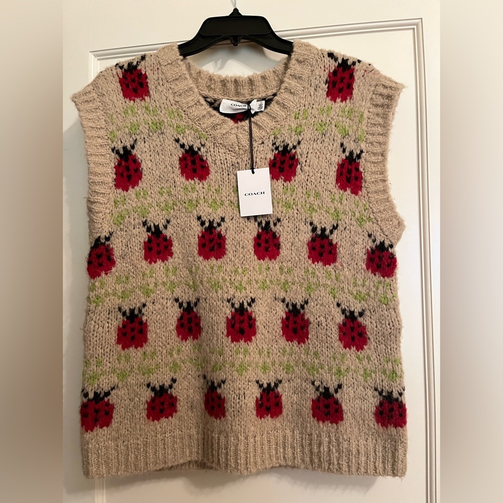 “FALL ESSENTIAL” Beautiful vest by COACH with ladybug detail.